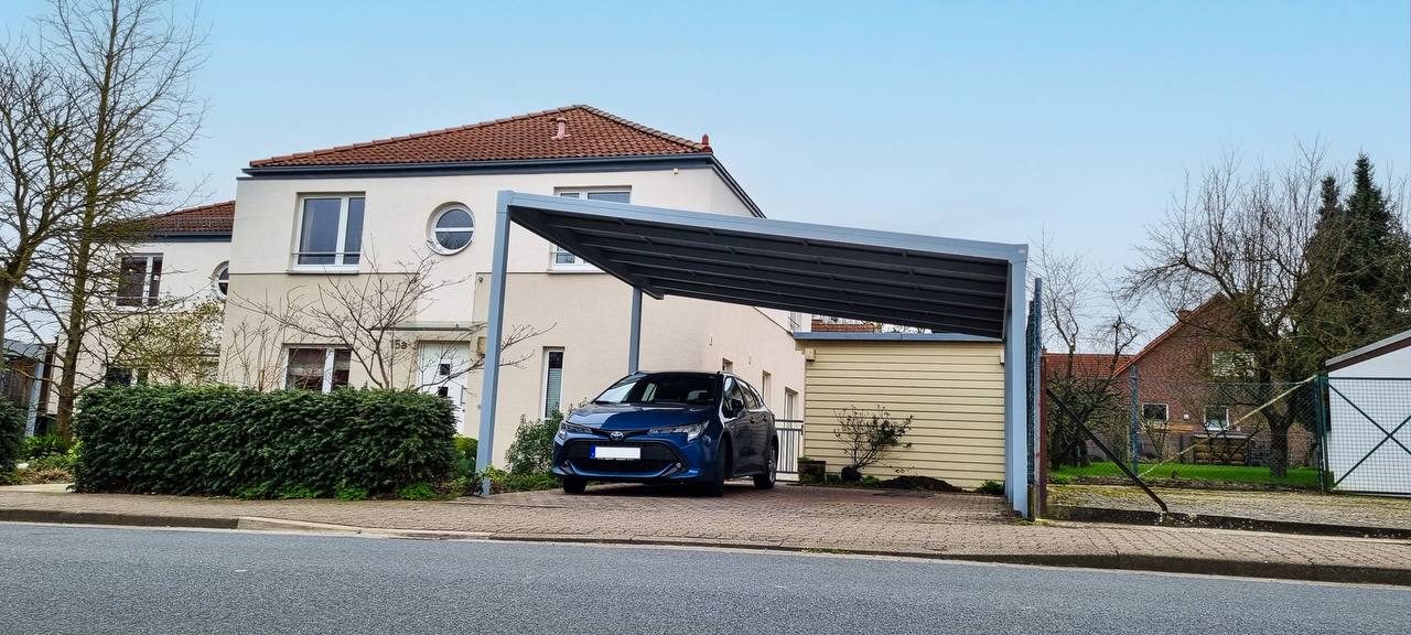 Carport aus Aluminium vor einem Einfamilienhaus